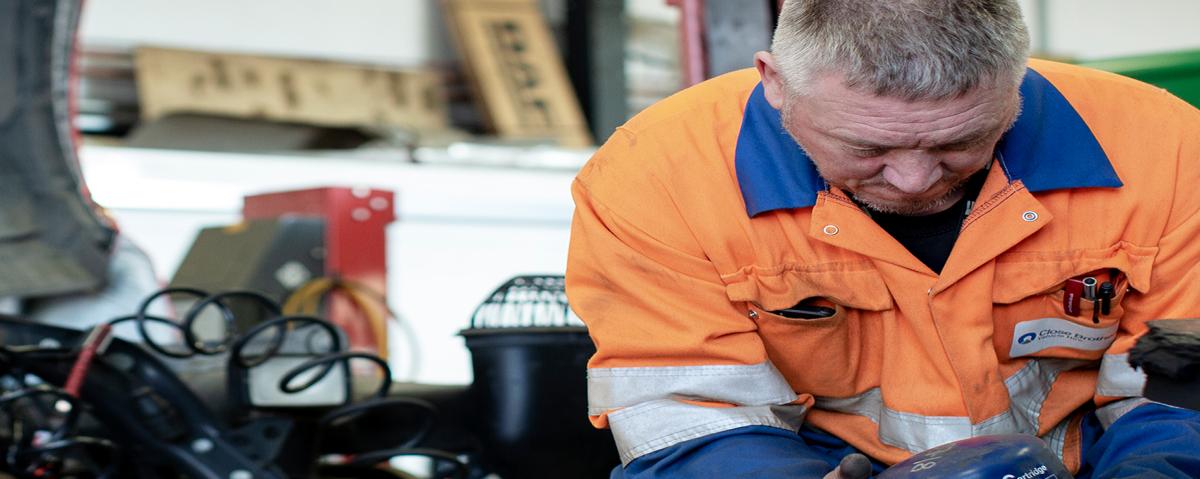 Car mechanic looking at parts